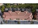 Top-down view of townhouses with tiled roofs and private patios at 2627 Bugatti Ct, Kissimmee, FL 34746