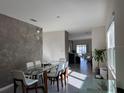 Bright dining area with glass table and modern chairs at 2843 Turnstone Run, Harmony, FL 34773
