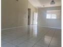 Spacious living room with light walls and tiled floors at 34 Pine Island Cir, Kissimmee, FL 34743
