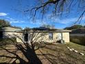 Back of house featuring solar panels and a sliding glass door at 449 Heather Hill Blvd, Davenport, FL 33837
