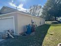 Side view of house with a garage and some building materials at 449 Heather Hill Blvd, Davenport, FL 33837