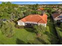House with orange tile roof and screened patio overlooking green space at 542 Viterra Ct, Kissimmee, FL 34759