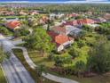 Community overview featuring houses, lake, and lush green spaces at 542 Viterra Ct, Kissimmee, FL 34759