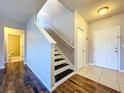 Entryway with staircase, wood floors, and view into bathroom at 627 Lucerne Blvd, Winter Haven, FL 33881