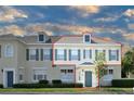 Two-story townhome with gray shutters and a neutral color scheme at 720 Siena Palm Dr # 202, Celebration, FL 34747
