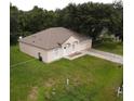 Single story house with a two car garage and a large yard at 796 Del Prado Dr, Kissimmee, FL 34758