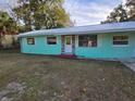 Recently painted teal single-story home with stone accents at 1420 Ne 22Nd St, Ocala, FL 34470