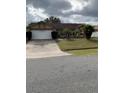 Two-car garage and a neatly landscaped front yard at 306 Medina Ct, Kissimmee, FL 34758