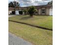 Landscaped yard, driveway, and a one-car garage at 306 Medina Ct, Kissimmee, FL 34758