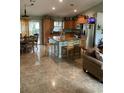 Spacious kitchen with an island, wood cabinets, and tile flooring at 306 Medina Ct, Kissimmee, FL 34758