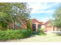 Well-maintained home with lush landscaping, creating curb appeal at 521 Milano Rd, Kissimmee, FL 34759