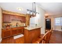 Charming kitchen with wood cabinets, granite countertops, and modern appliances at 7709 Ravenna Ave, Orlando, FL 32819