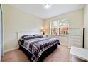 Spacious bedroom with a white dresser and a plaid comforter at 8958 Sugar Palm Rd, Kissimmee, FL 34747