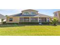 House back elevation showcasing a screened patio and spacious backyard at 1280 Osprey Landing Dr, Lakeland, FL 33813