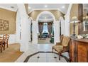 Elegant entryway with arched doorways and tile floors at 1501 Sunset Pointe Pl, Kissimmee, FL 34744