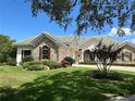 Luxury home with stone accents and lush landscaping at 1501 Sunset Pointe Pl, Kissimmee, FL 34744