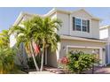 Two-story house with light beige siding, a two-car garage, and landscaping at 3112 Armstrong Spring Dr, Kissimmee, FL 34744