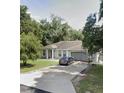 Single-story house with a driveway and lawn at 12 Larch Radl, Ocala, FL 34480