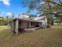 Older home with large front porch and mature trees at 6106 Pine Nw Ave, Lakeland, FL 33810