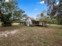 White house with covered porch and large backyard at 6106 Pine Nw Ave, Lakeland, FL 33810
