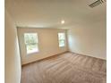 Spacious bedroom with neutral carpeting and natural light at 14927 Sw 25Th Cir, Ocala, FL 34473