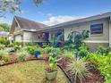 Villa with vibrant garden and front porch at 9460 Sw 84Th Ter # F, Ocala, FL 34481