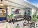 Inviting front porch with wicker furniture and lush landscaping at 9460 Sw 84Th Ter # F, Ocala, FL 34481