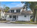 Front view of a renovated two-story house with white siding at 405 S Ridgewood Ave, Daytona Beach, FL 32114