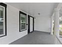 Spacious front porch with white columns and gray flooring at 405 S Ridgewood Ave, Daytona Beach, FL 32114