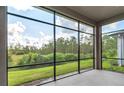 Spacious screened porch overlooking a lush green backyard at 128 Mosaic Blvd, Daytona Beach, FL 32124
