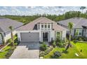 One-story house with gray siding, brown roof, and a screened porch in a residential neighborhood at 128 Mosaic Blvd, Daytona Beach, FL 32124