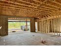 Interior framing of new construction with a view to the back at 6411 Highfield Village Dr, Port Orange, FL 32128