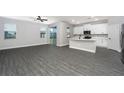 Open living space with kitchen, wood-look floors, and access to patio at 3327 Chinotto Dr, Lake Alfred, FL 33850