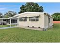 Landscaped manufactured home with awning and steps at 1610 Reynolds Rd # 5, Lakeland, FL 33801