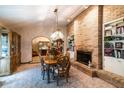 Elegant dining room featuring a brick fireplace, built-in shelving, and a wood table at 8723 A D Mims Rd, Orlando, FL 32818