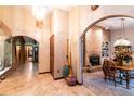 Bright entryway with tile flooring, arched doorways, and views into the dining room and beyond at 8723 A D Mims Rd, Orlando, FL 32818