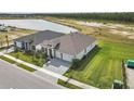 Two houses, one with a stone facade, seen from above, near a lake at 389 Mosaic Blvd, Daytona Beach, FL 32124
