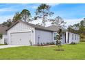 House exterior with gray siding and two-car garage at 616 Marion Oaks Blvd, Ocala, FL 34473