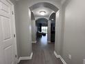 Bright entryway with wood-look floors, leading to living area at 14501 Grove Resort Ave # 1617, Winter Garden, FL 34787