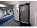 Modern hallway with blue and gray carpeting at 14501 Grove Resort Ave # 1617, Winter Garden, FL 34787