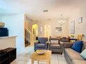 Spacious living room with seating and stairs at 2705 Bushman Dr, Kissimmee, FL 34746