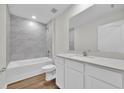 Bathroom with a bathtub, toilet, and vanity with a quartz countertop at 14192 Sw 44Th Ct, Ocala, FL 34473