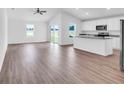 Open living room and kitchen with vinyl plank floors at 14192 Sw 44Th Ct, Ocala, FL 34473