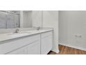 Double vanity bathroom with quartz countertop and glass shower at 14192 Sw 44Th Ct, Ocala, FL 34473