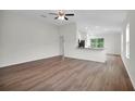 Open living room with hardwood floors, kitchen island, and access to backyard at 560 Marion Oaks Mnr, Ocala, FL 34473
