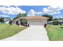 Single-story house with two-car garage and landscaping at 2163 Rainbower Ct, Lakeland, FL 33810