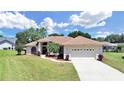 Single-story house with two-car garage and landscaping at 2163 Rainbower Ct, Lakeland, FL 33810