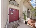 Double door entry with welcome mat and plants at 2163 Rainbower Ct, Lakeland, FL 33810