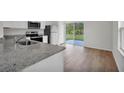 Kitchen with granite countertops, stainless steel appliances, and backyard access at 523 Marion Oaks Blvd, Ocala, FL 34473