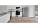Modern kitchen with stainless steel appliances and granite countertops at 523 Marion Oaks Blvd, Ocala, FL 34473
